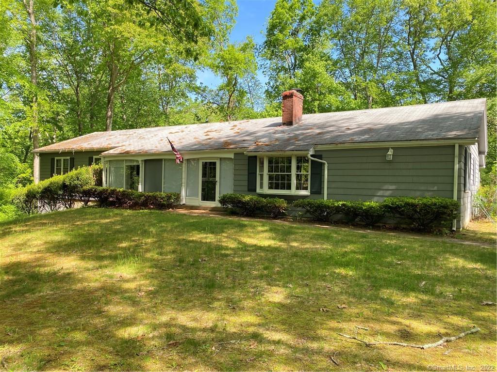 5 Williamsburg Road Marlborough, CT 06447 - Photo 1 of 1 a front view of a house with a yard table and chairs