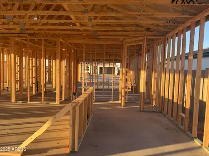 a view of empty room with wooden floor and windows