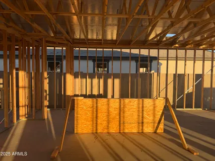 a view of a house with a door and wooden fence