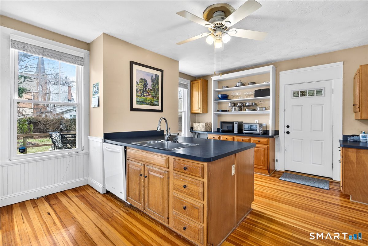 95 Clark Street New Haven, CT 06511 - Photo 11 of 39 a kitchen with stainless steel appliances granite countertop a stove a sink and a refrigerator with wooden floor