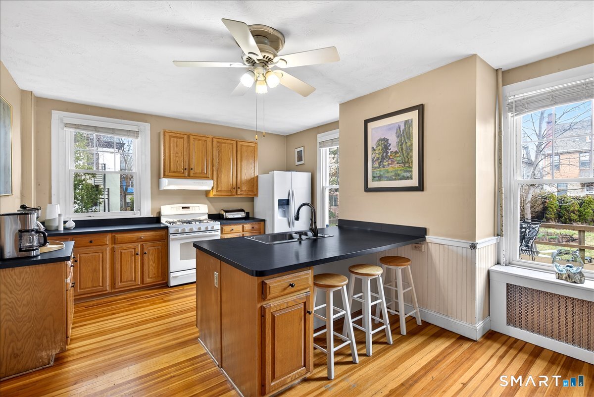95 Clark Street New Haven, CT 06511 - Photo 14 of 39 a kitchen with stainless steel appliances a table and chairs in it
