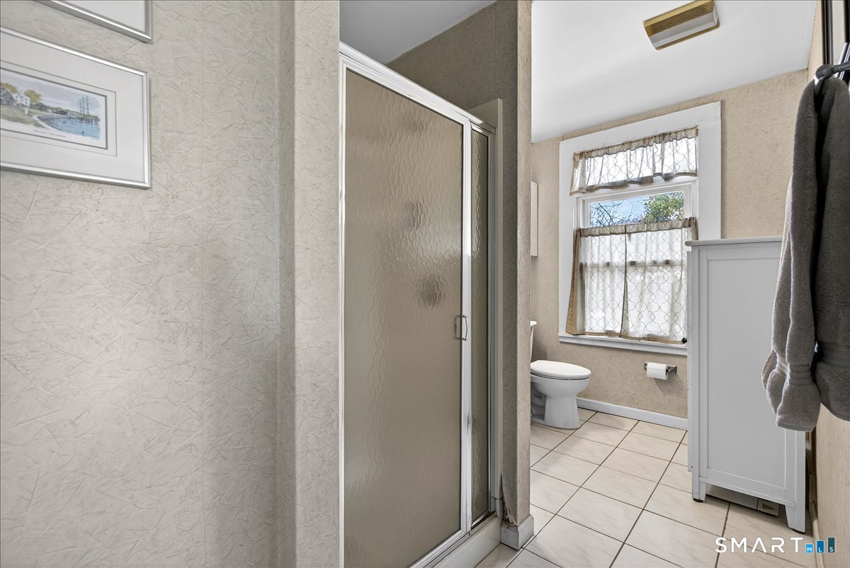 95 Clark Street New Haven, CT 06511 - Photo 24 of 39 a bathroom with a granite countertop window a toilet and a shower