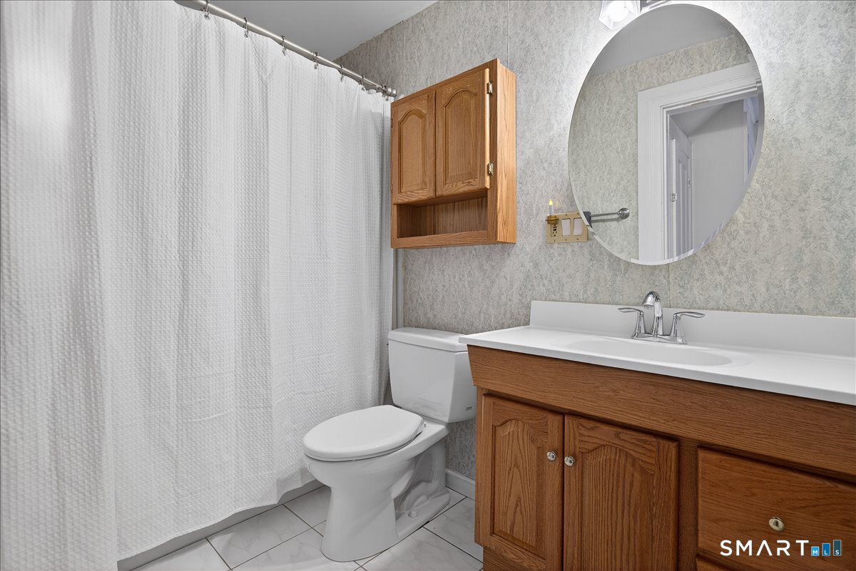 95 Clark Street New Haven, CT 06511 - Photo 28 of 39 a bathroom with a sink a toilet and a mirror
