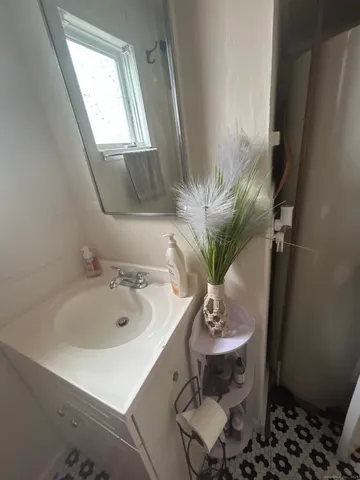 a bathroom with a sink a mirror and a window