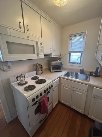 a kitchen with appliances cabinets and a sink
