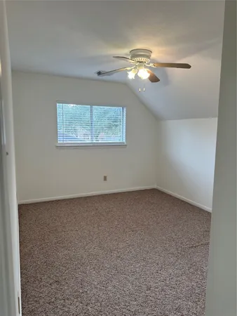 a view of a chandelier fan in an empty room