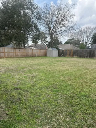 a view of a backyard with large trees