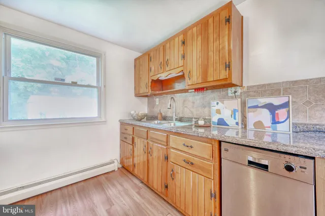 a kitchen with stainless steel appliances granite countertop a sink and cabinets