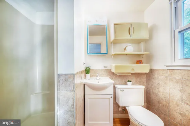 a white toilet sitting next to a bathroom sink