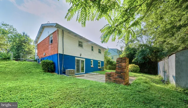 a view of a house with a yard and tree