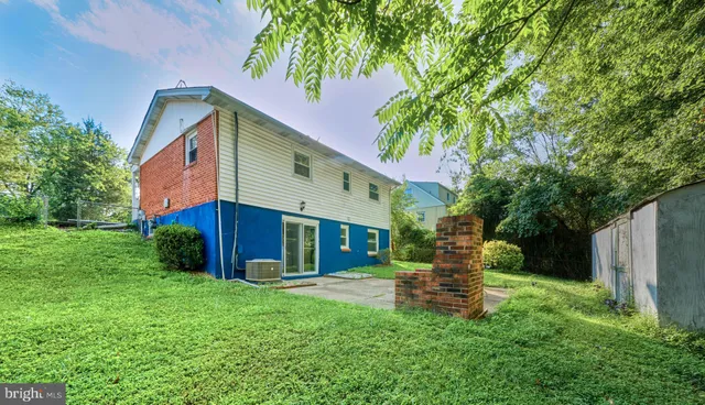 a view of a house with a yard and tree s