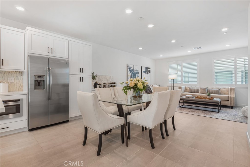 285 Lodestar Tustin, CA 92782 - Photo 18 of 40 a dining room with furniture and a kitchen view