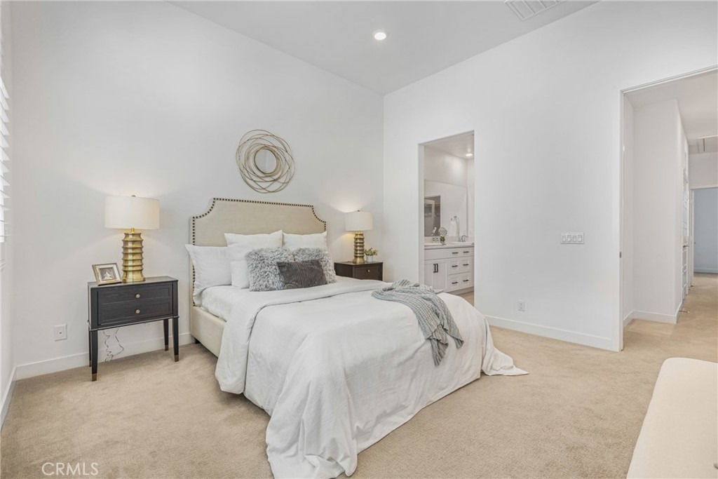 285 Lodestar Tustin, CA 92782 - Photo 25 of 40 a bed room with a bed and a lamp