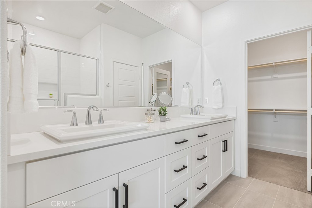 285 Lodestar Tustin, CA 92782 - Photo 27 of 40 a bathroom with double vanity sink a mirror and a shower