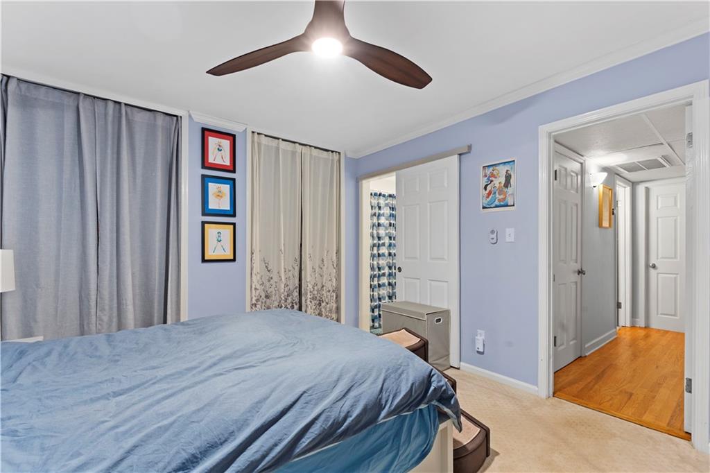 5400 Roswell Road, Unit L6 Sandy Springs, GA 30342 - Photo 17 of 19 a bedroom with a bed and a chandelier