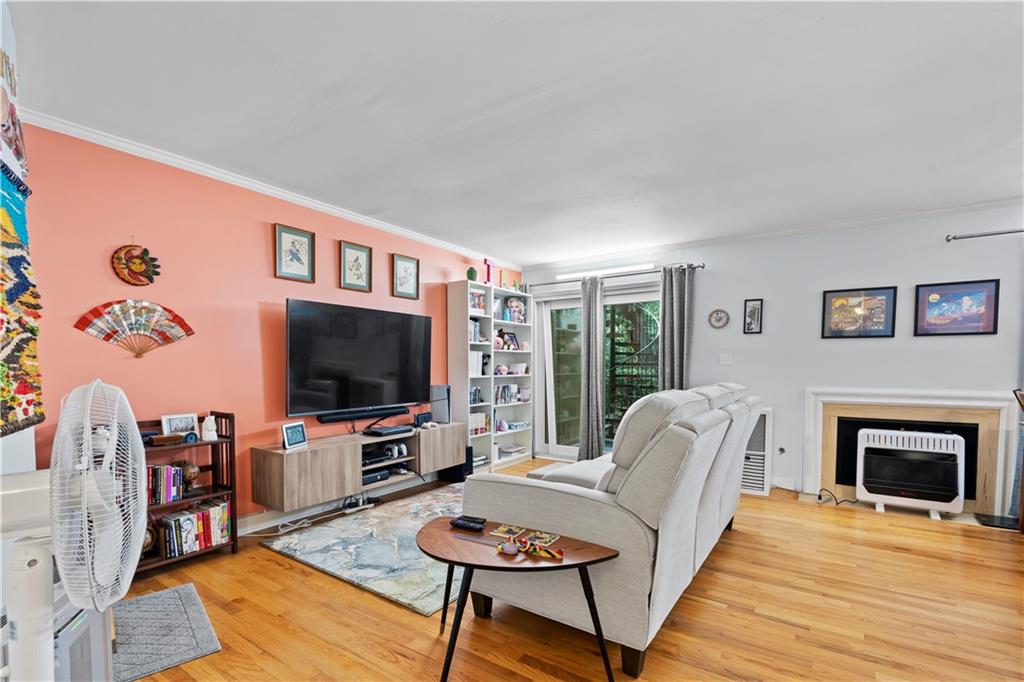 5400 Roswell Road, Unit L6 Sandy Springs, GA 30342 - Photo 6 of 19 a living room with furniture a flat screen tv and a fireplace