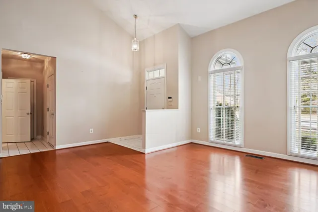 a kitchen with white cabinets and sink