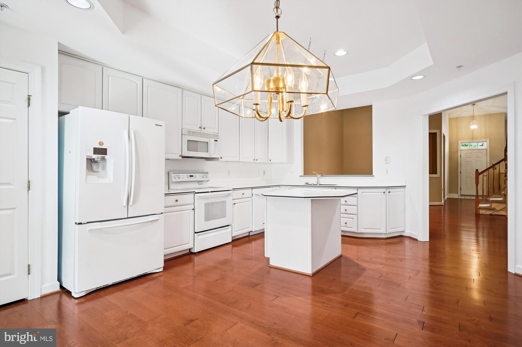328 Colony Point Place Edgewater, MD 21037 - Photo 17 of 89 a kitchen with white cabinets and white appliances