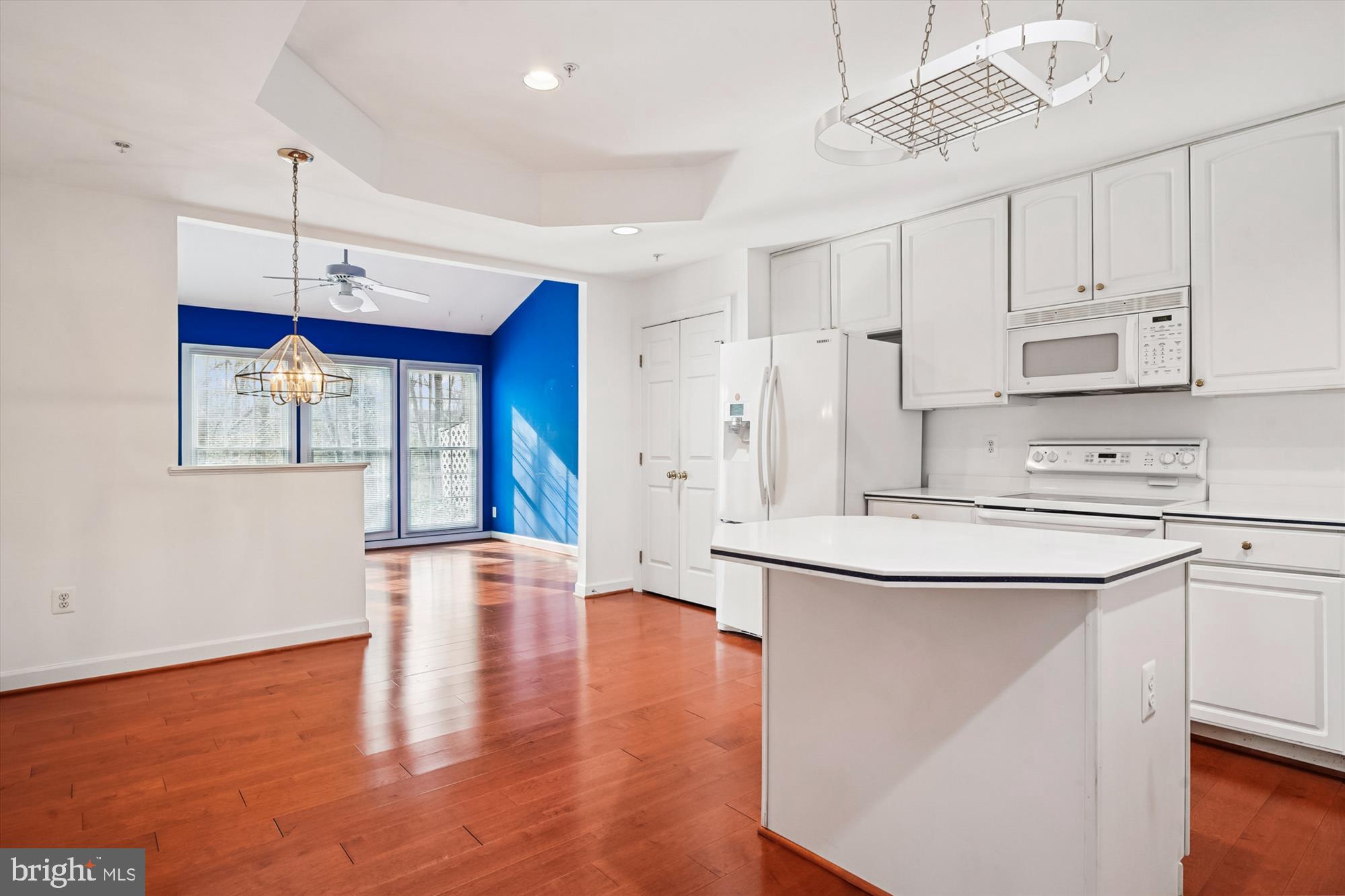 328 Colony Point Place Edgewater, MD 21037 - Photo 27 of 89 a kitchen with stainless steel appliances granite countertop a sink a stove a refrigerator and white cabinets with wooden floor