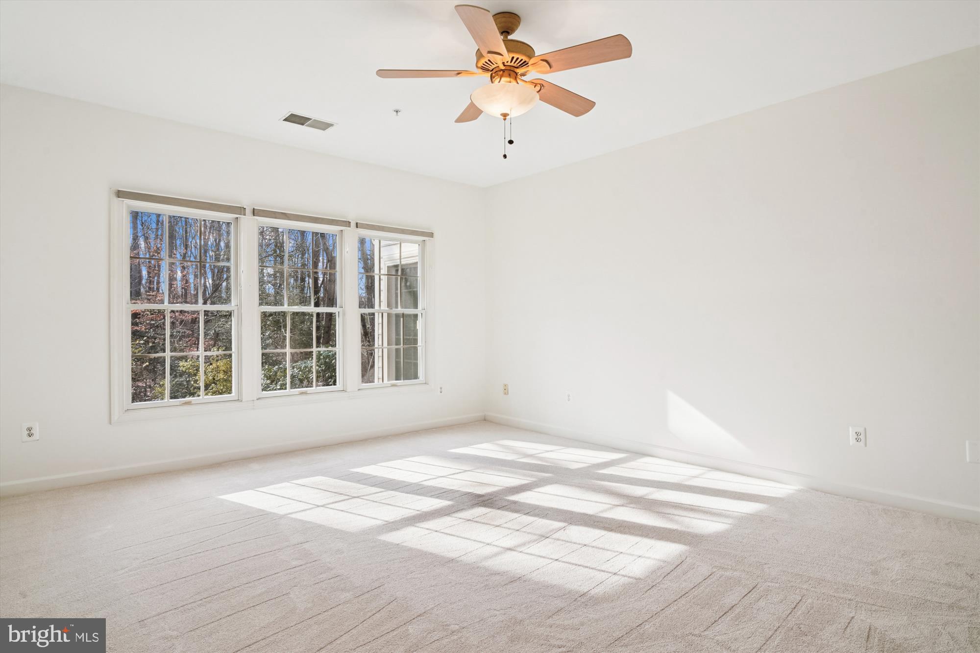 328 Colony Point Place Edgewater, MD 21037 - Photo 34 of 89 a view of an empty room with a window and a ceiling fan