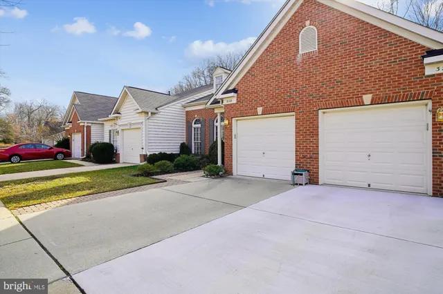 a view of house with yard and large tree in front of it