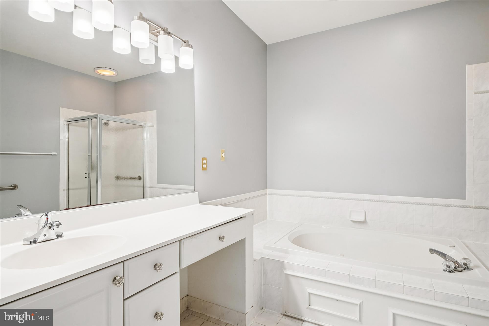 328 Colony Point Place Edgewater, MD 21037 - Photo 41 of 89 a bathroom with a sink and a mirror with bathtub