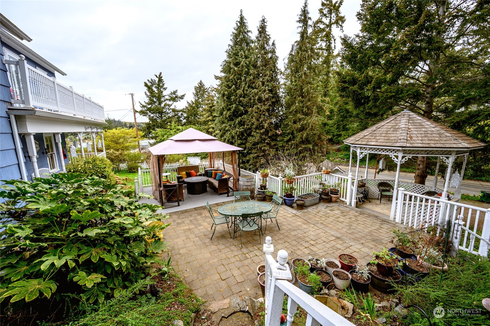 503 South 3rd Street La Conner, WA 98257 - Photo 32 of 39 an outdoor space with patio furniture and white umbrellas