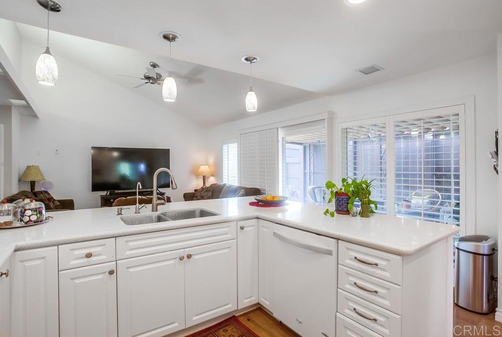 12705 Coachman Court Poway, CA 92064 - Photo 10 of 29 a kitchen with a sink a counter cabinets and appliances