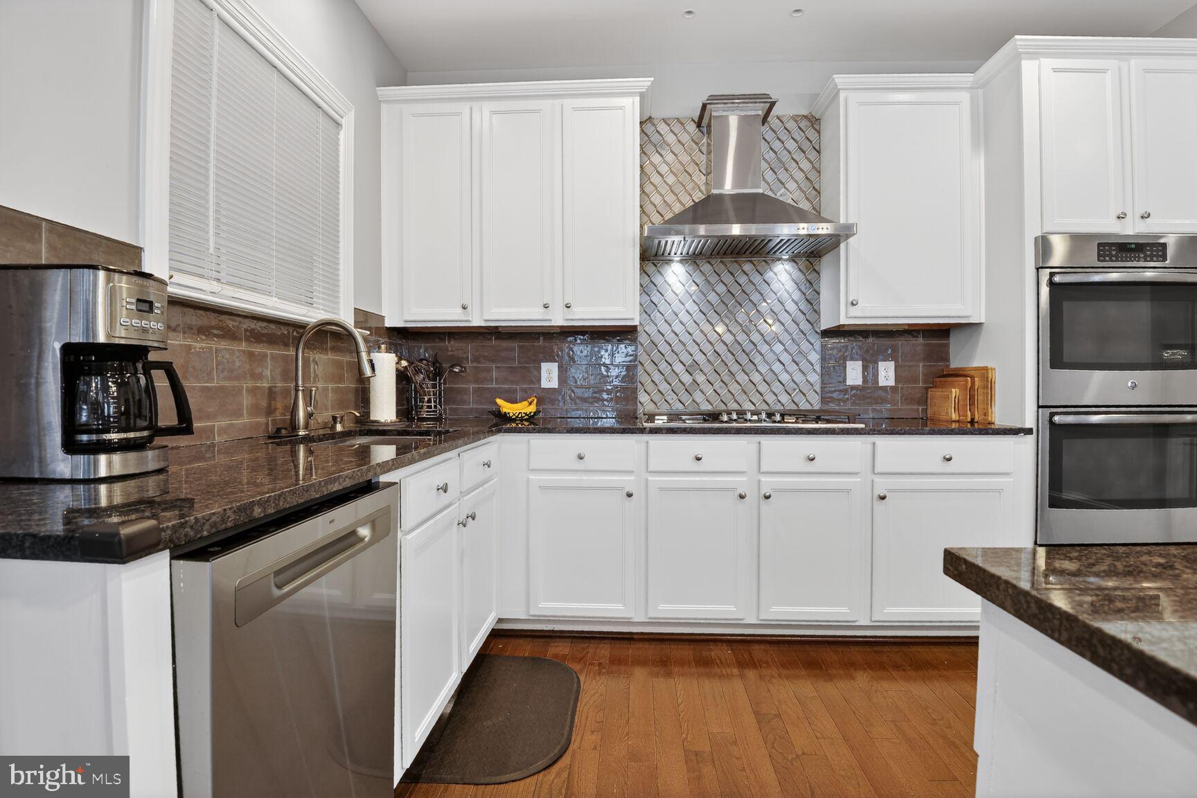 8808 Talbert Road Lorton, VA 22079 - Photo 11 of 52 a kitchen with stainless steel appliances granite countertop a sink stove and cabinets