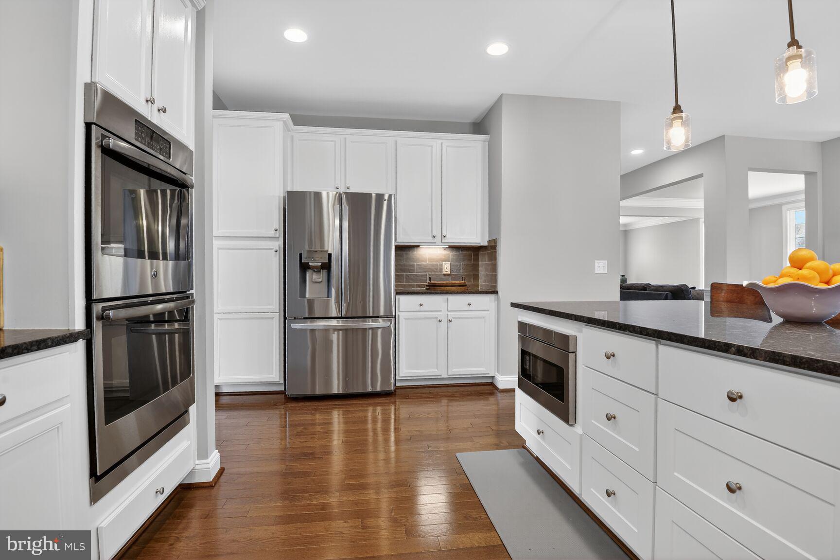8808 Talbert Road Lorton, VA 22079 - Photo 12 of 52 a kitchen with stainless steel appliances a refrigerator sink and cabinets