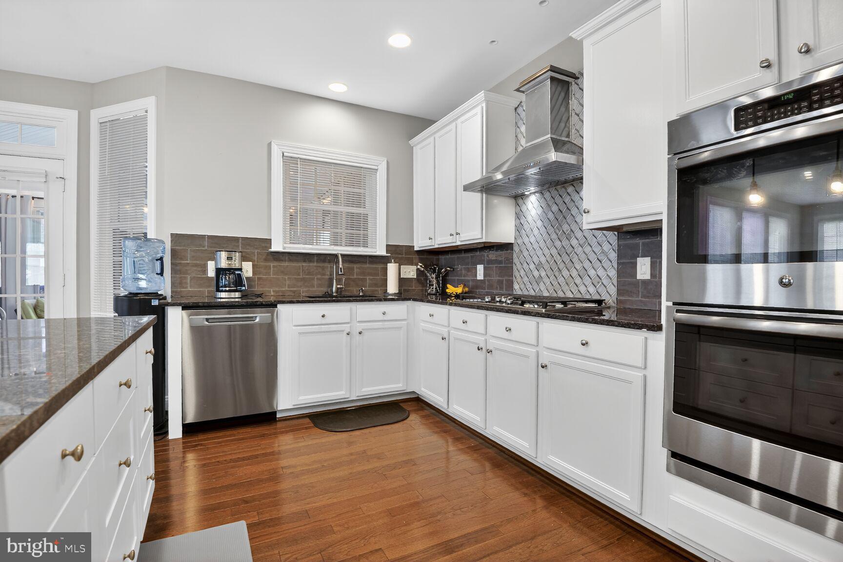 8808 Talbert Road Lorton, VA 22079 - Photo 14 of 52 a kitchen with granite countertop a sink cabinets and stainless steel appliances