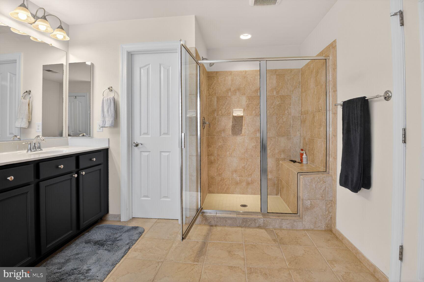 8808 Talbert Road Lorton, VA 22079 - Photo 30 of 52 a bathroom with a shower sink and mirror