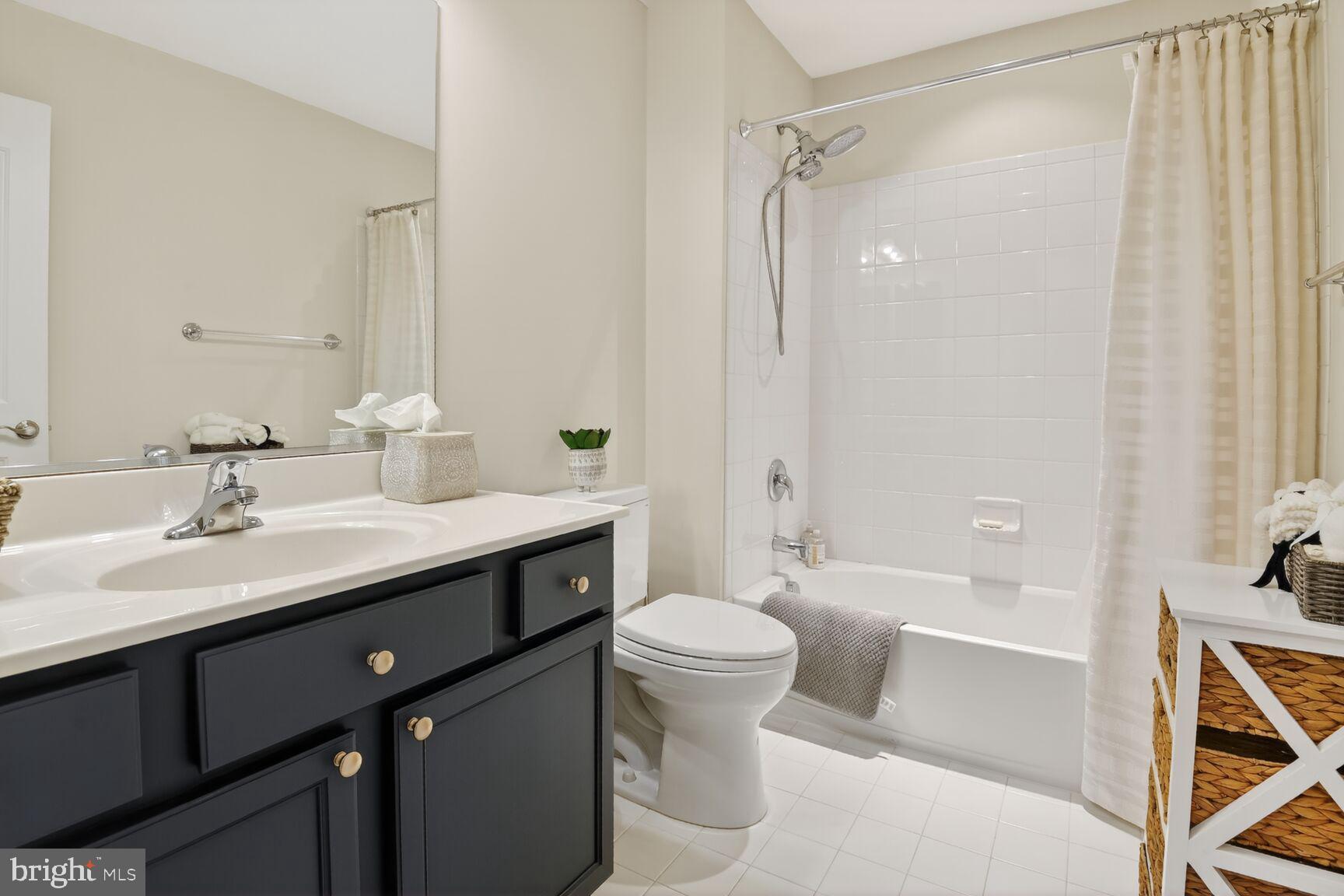 8808 Talbert Road Lorton, VA 22079 - Photo 31 of 52 a bathroom with a sink a toilet and shower