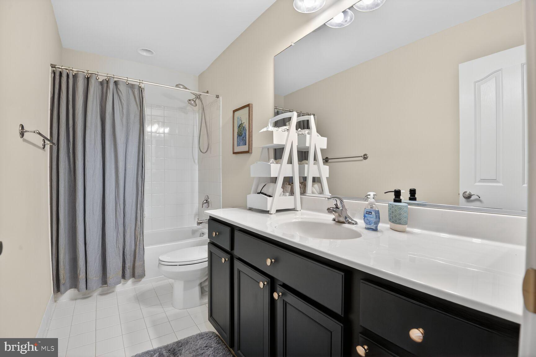 8808 Talbert Road Lorton, VA 22079 - Photo 33 of 52 a bathroom with a double vanity sink mirror and toilet
