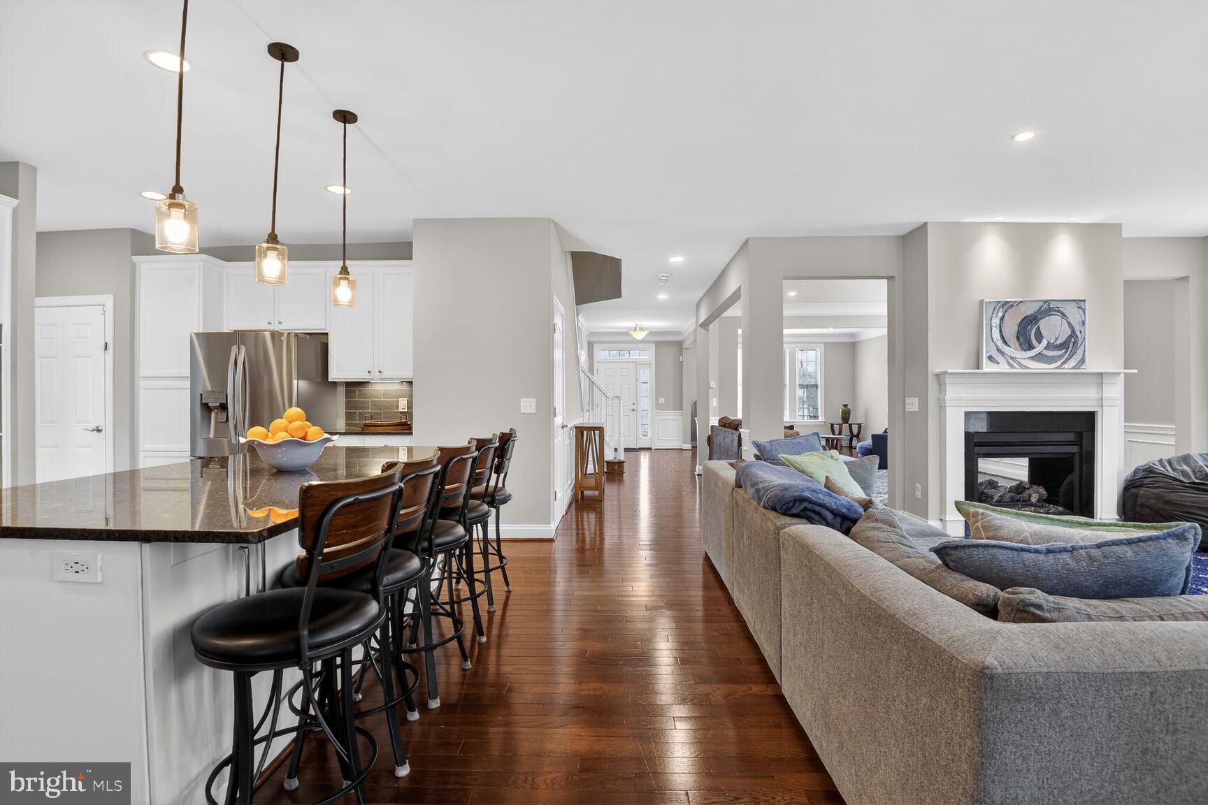 8808 Talbert Road Lorton, VA 22079 - Photo 9 of 52 a living room with furniture a fireplace and a chandelier