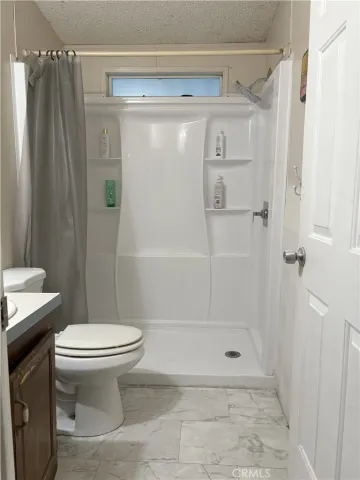 a bathroom with a shower and a toilet