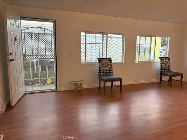a view of room with furniture and wooden floor