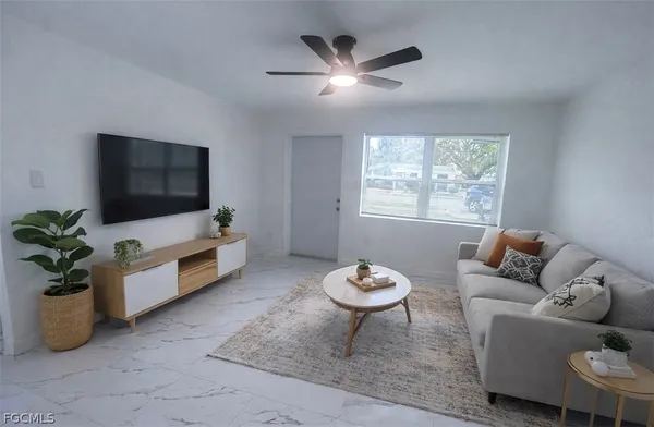 a living room with furniture and a flat screen tv