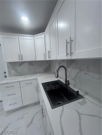 a kitchen with a sink and cabinets