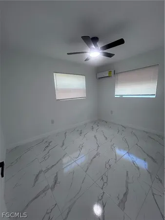 an empty room with a empty space and windows