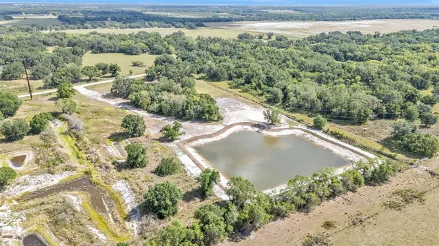 a view of a lake with beach and green space