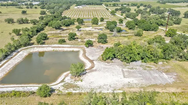 a white bath tub sitting in the middle of a lake