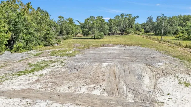 a view of field with trees in the background