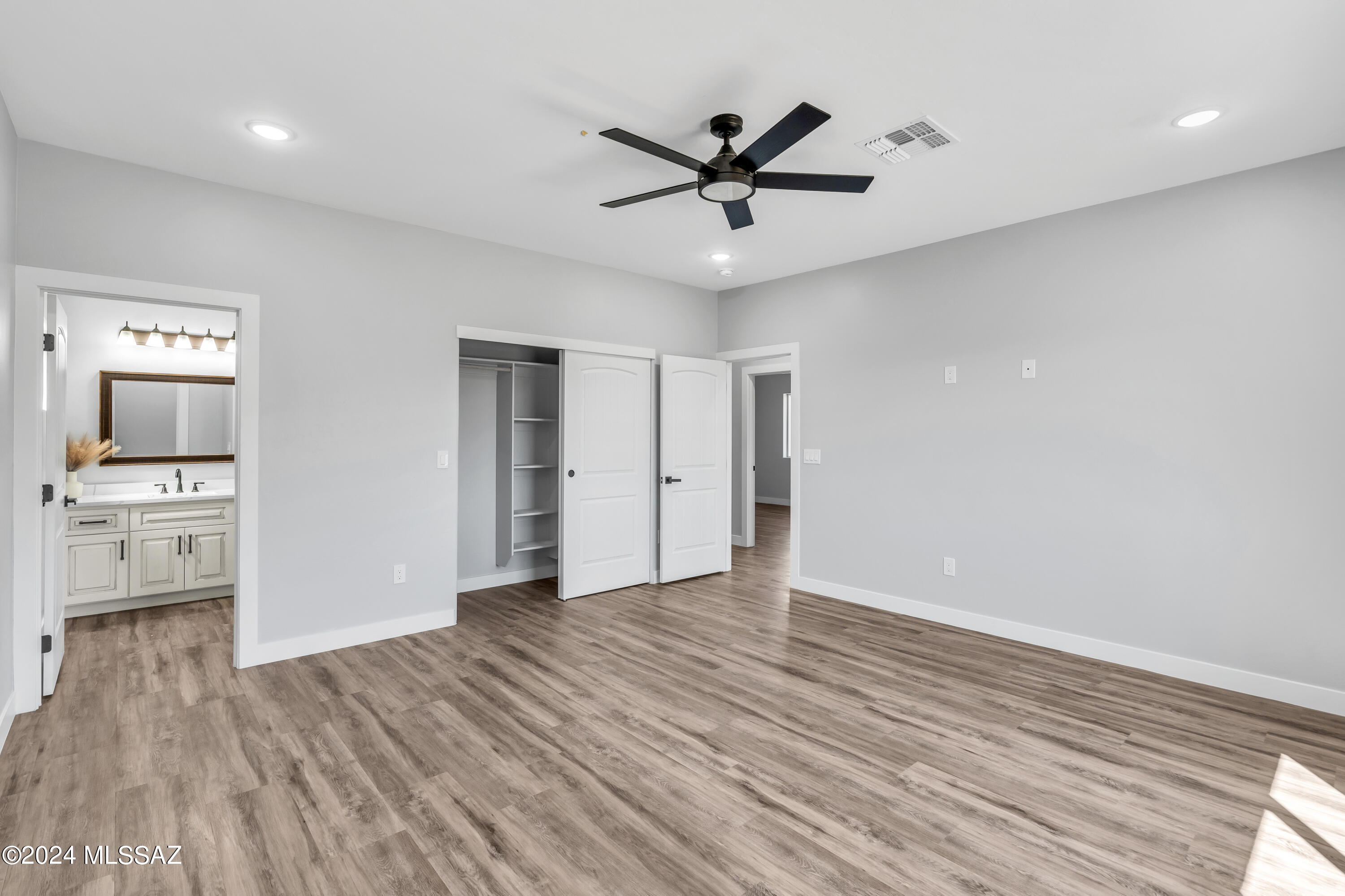 1849 Circulo Mexicali Rio Rico, AZ 85648 - Photo 21 of 29 a view of a livingroom with wooden floor a ceiling fan and windows