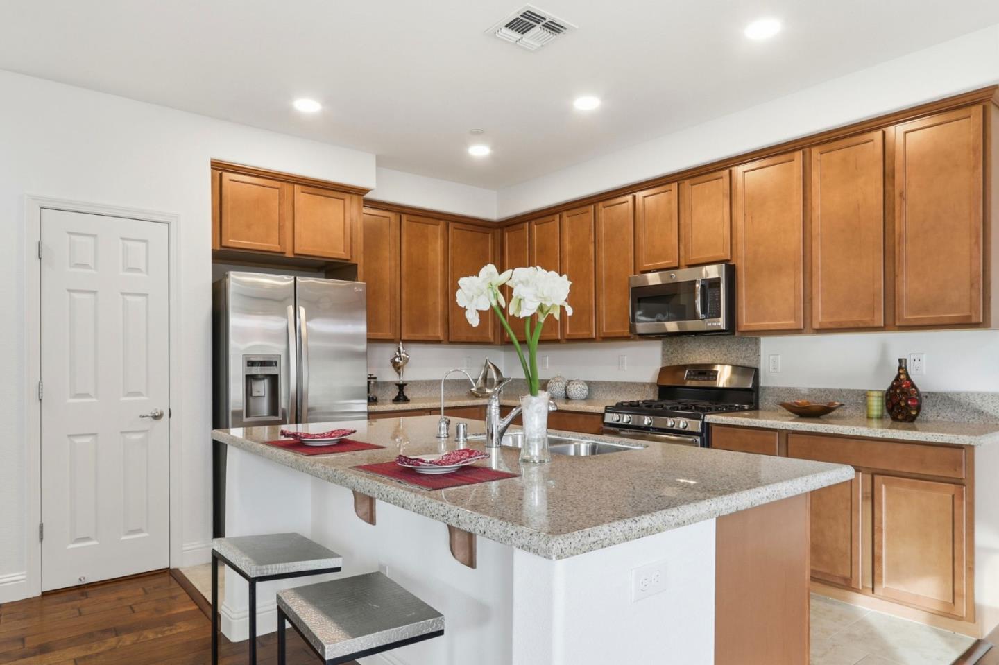 1550 Bleecker Street Milpitas, CA 95035 - Photo 5 of 35 a kitchen with stainless steel appliances granite countertop a sink stove and cabinets