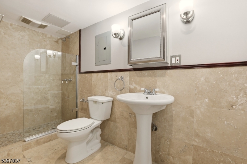 68-86 New England Avenue, Unit 18 Summit, NJ 07901 - Photo 11 of 14 a bathroom with a sink a toilet and shower