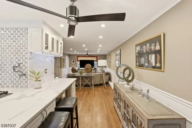 a very nice looking dining room with a large window and chandelier