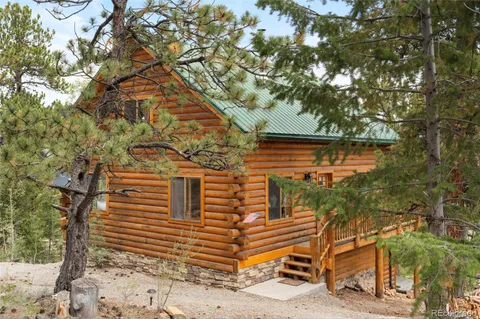 a yellow house with trees in front of it