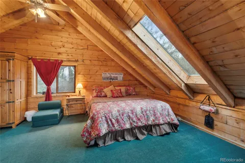 a bedroom with furniture and a window