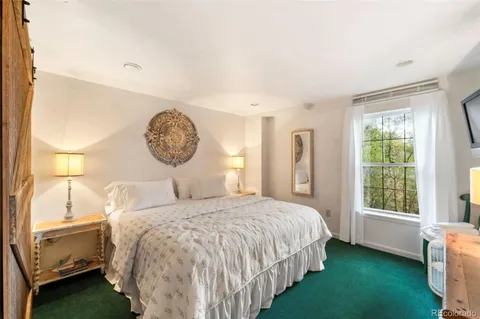 a bedroom with a bed and a window in it